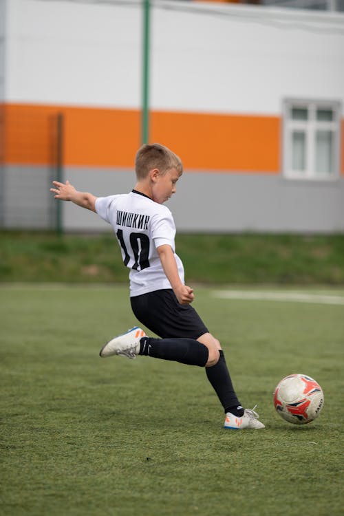Boy in White Jersey Playing Soccer