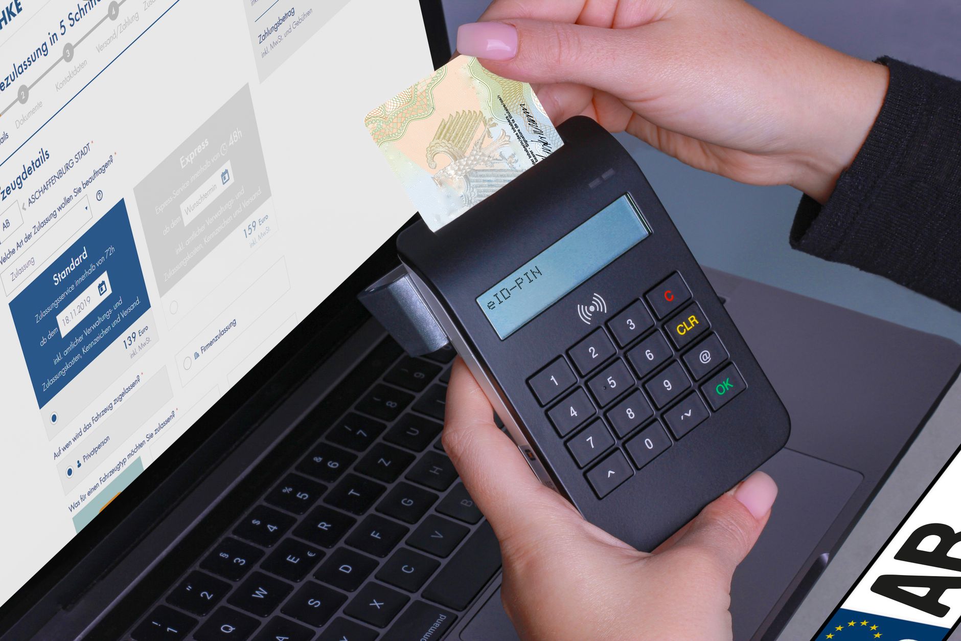 Close-up of a contactless payment using a card reader and laptop, highlighting digital security.