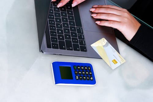 A Person in Black Long Sleeves Typing on Laptop