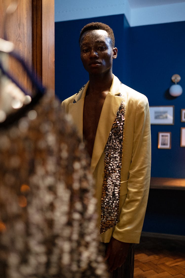 Man In Satin Yellow Jacket Standing In Fashion Studio