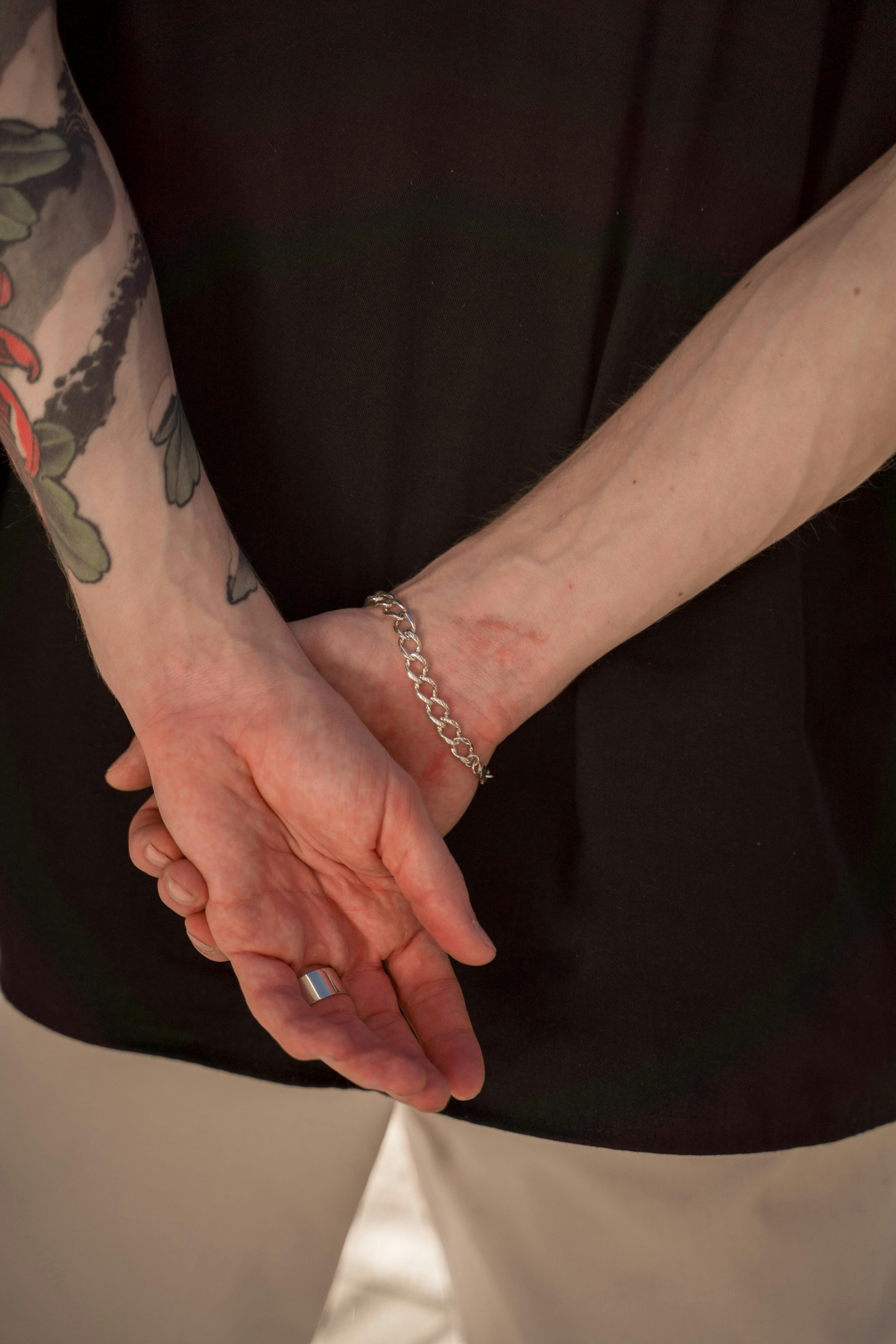 A woman with a tattoo on her arm wearing a bracelet photo – Free Yellow  Image on Unsplash