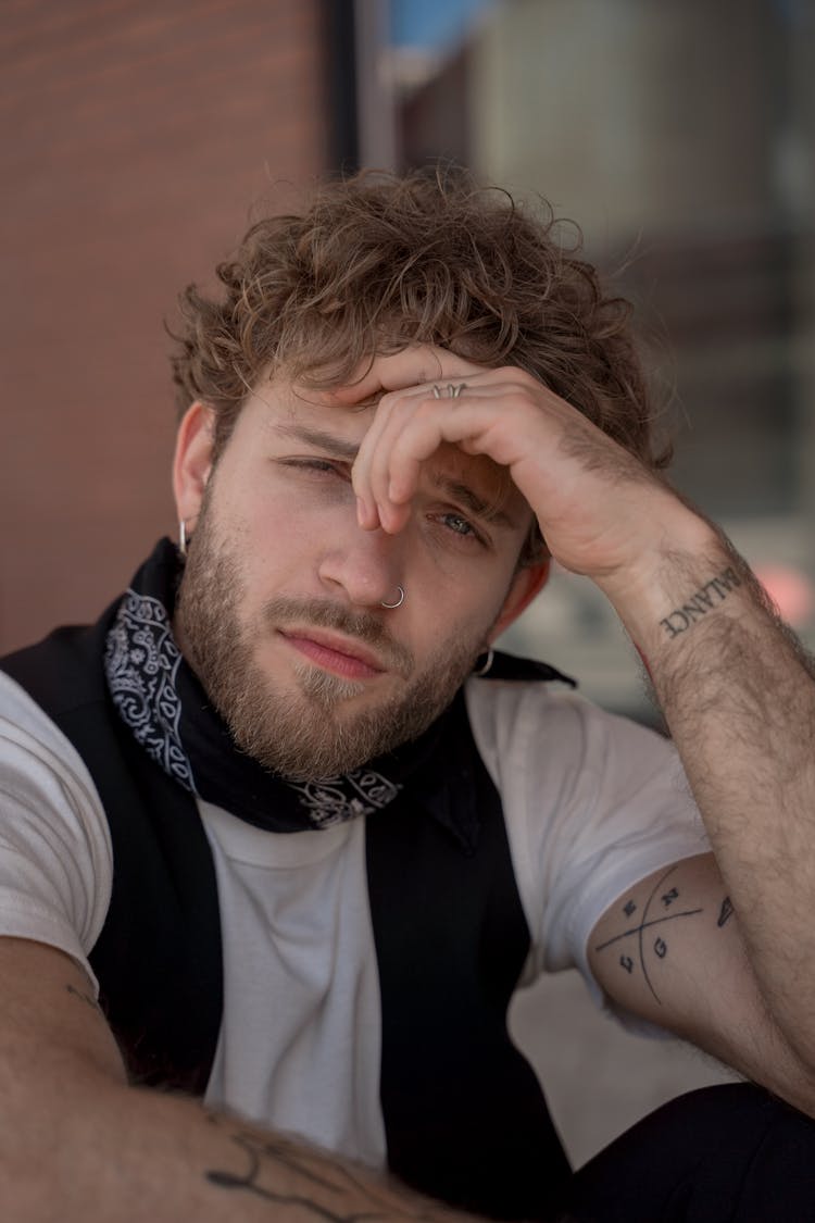 Bearded Man With Hand On Forehead