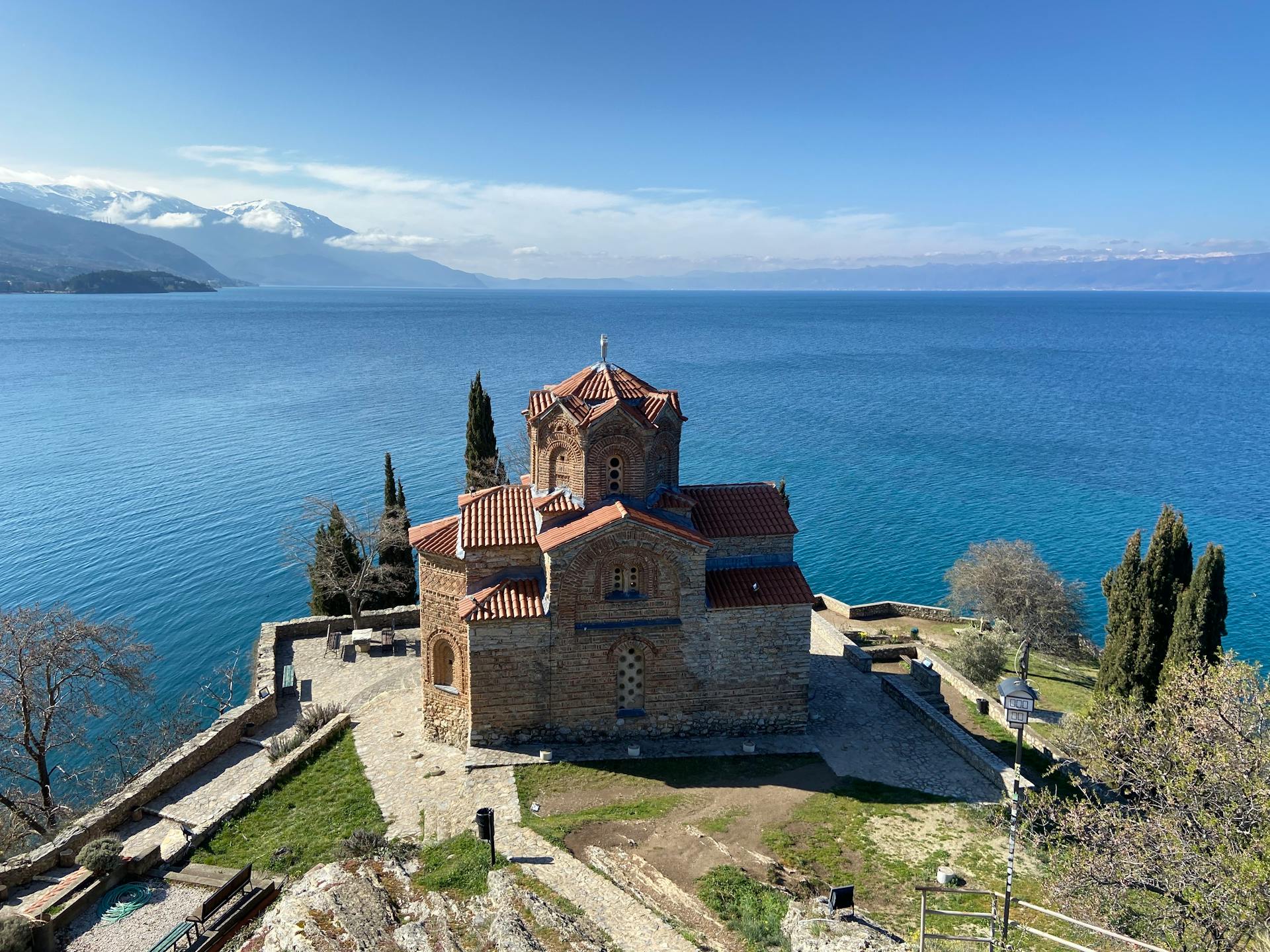 Aerial view of Saint John the Theologian Church by Lake Ohrid, North Macedonia, on a clear day.