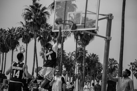 Dynamic black-and-white outdoor basketball game showcasing athleticism in Los Angeles.