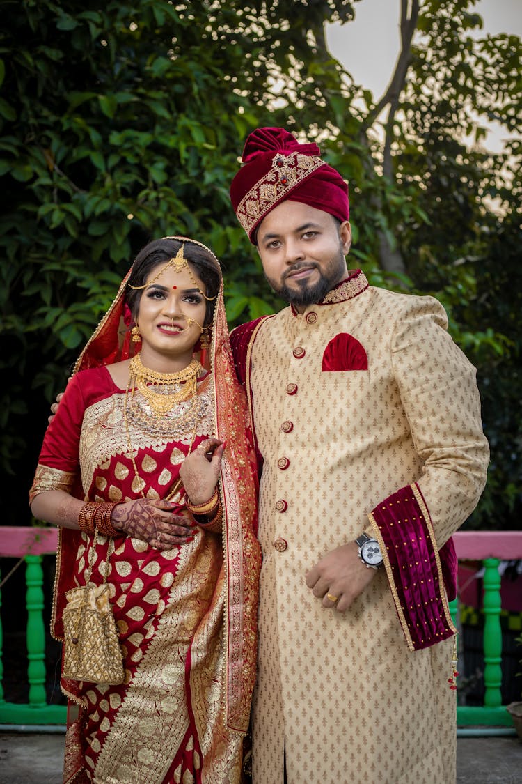 A Man In Sherwani Smiling And Posing