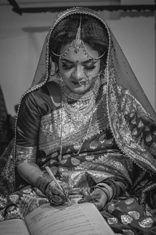 Grayscale Photo of a Bride Signing a Contract