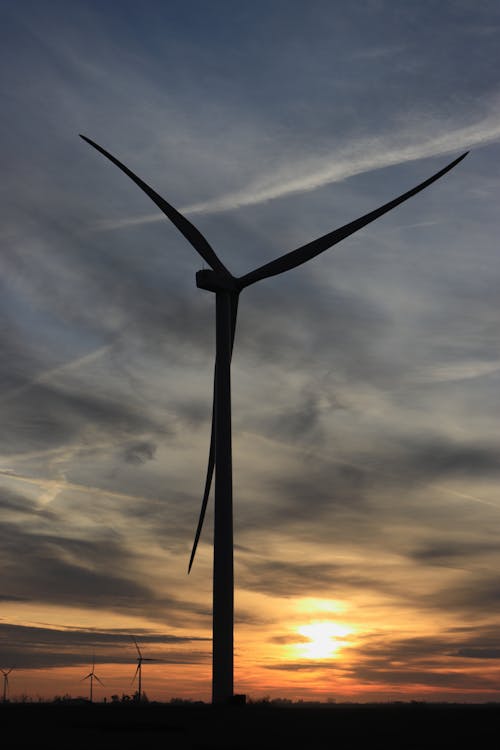 Free Black Wind Turbine Under Cloudy Sky during Sunset Stock Photo