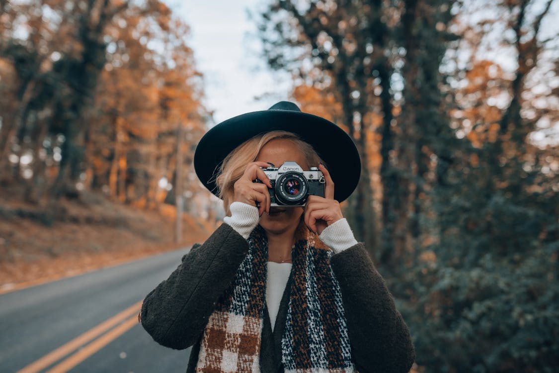 Free Woman Wearing Hat Taking Photo with a Camera Stock Photo