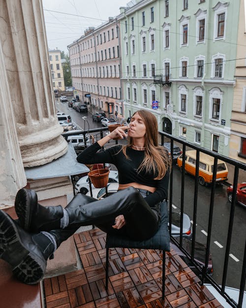 Woman Smoking Cigarette at the Balcony