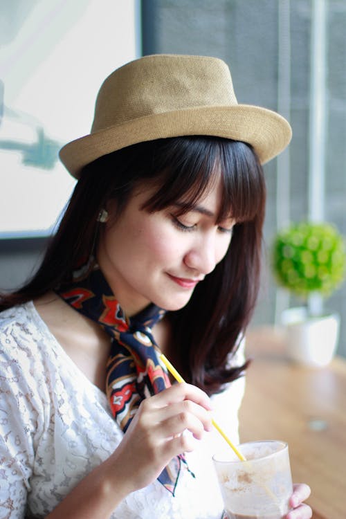 Close-Up Photography of a Woman Wearing Hat