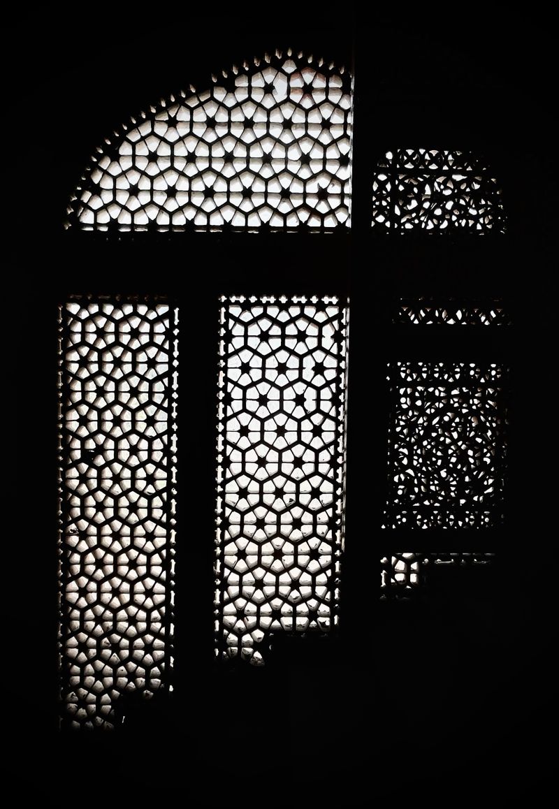 Backlit traditional jaali lattice window in Jaipur, India