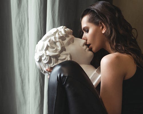 Woman Kissing a Statue