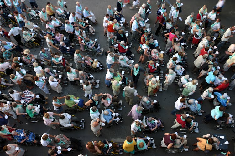 Group Of Disabled People Helped During A Religious Celebration In Lourdes, France