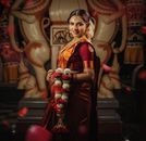 Woman in Red and Gold Sari Dress Holding Red Rose Bouquet