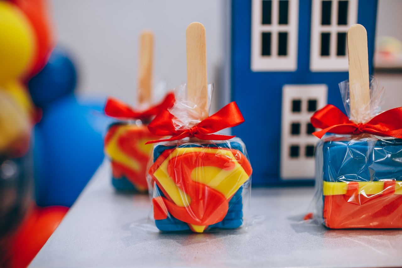 superman themed square lollipops with red bow perfect for birthday cel