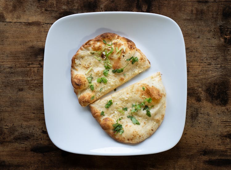 

A Plate Of A Cheese Garlic Naan