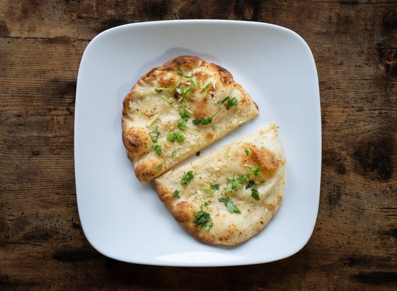 Garlic naan garnished with herbs