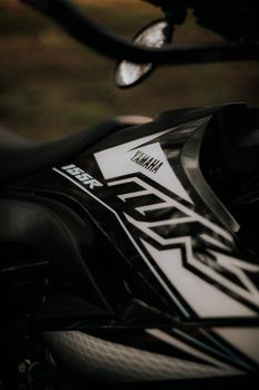 Detailed view of Yamaha WR155R motorcycle's side showing sleek design and branding.