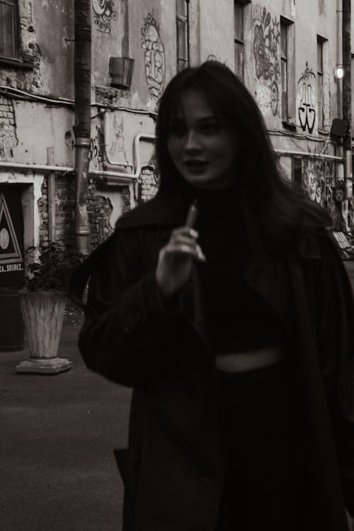 
A Grayscale of a Woman Wearing a Coat