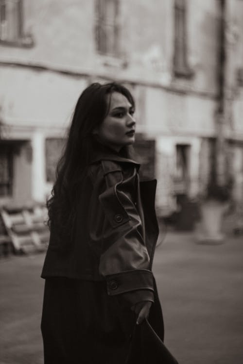 

A Grayscale of a Woman Wearing a Leather Coat