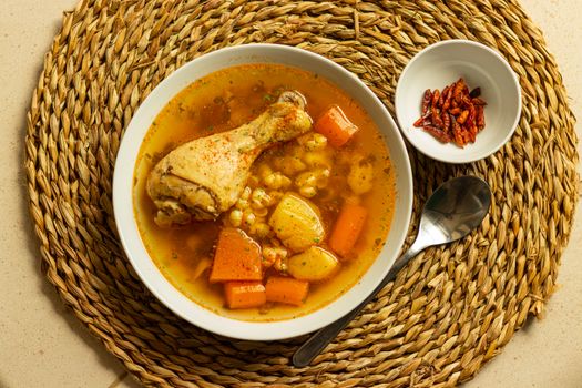Delicious Spanish chicken stew with vegetables in a rustic setting, perfect for cozy meals.