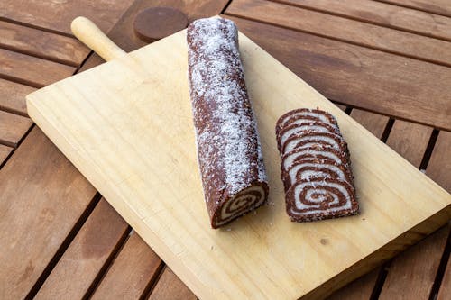 
A Sliced Swiss Roll on a Wooden Board