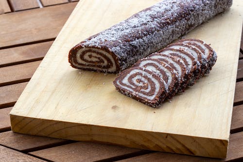 
A Sliced Swiss Roll on a Wooden Board