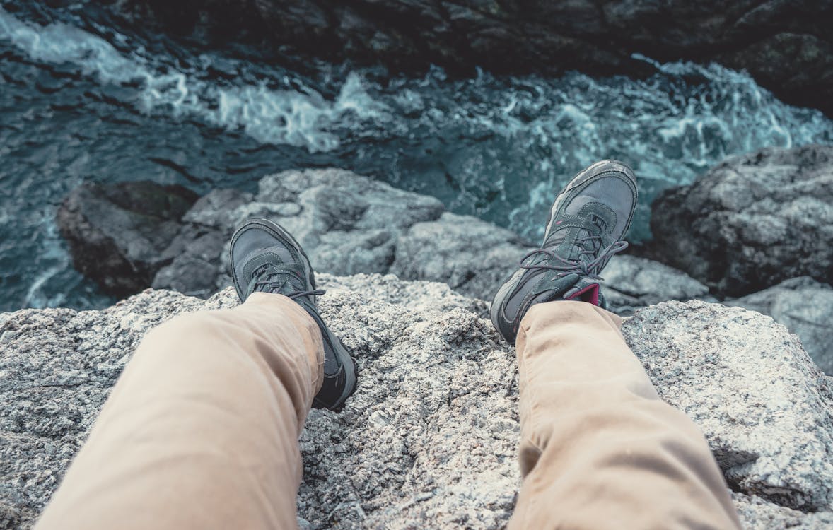 Photo of Man Sitting on the Cliff · Free Stock Photo