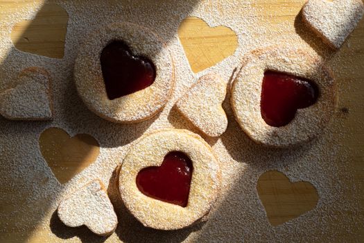 Delicious heart-shaped cookies filled with jam and dusted with powdered sugar.