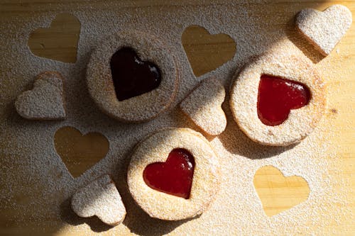 Free Pastry Products with Heart Shape Holes Filled with Jam Stock Photo