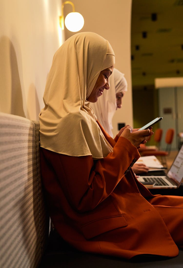 Woman Smiling While Texting