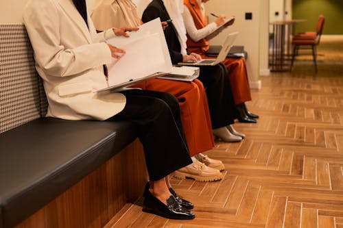 Women Sitting in Row on Bench