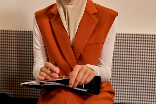 Woman Sitting Holding Pen