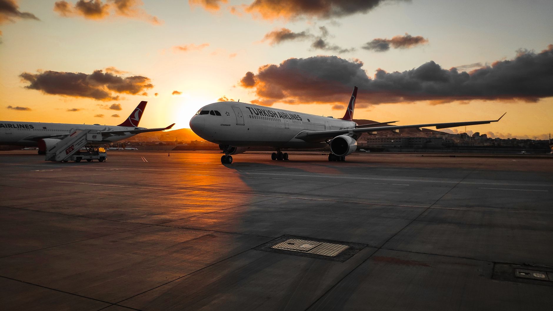 A Turkish Airlines plane on the tarmac at sunset in İstanbul, Turkey.