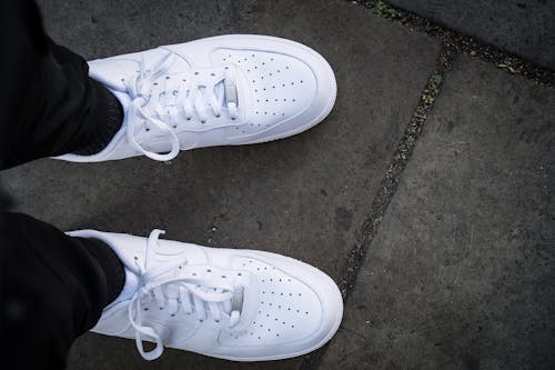 Free Person Wearing White Sneakers Stock Photo