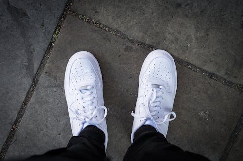 Person Wearing White Nike Sneakers