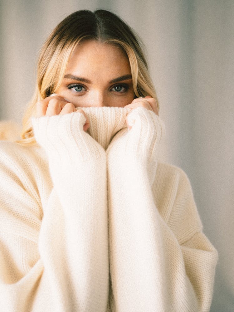 Woman With Face Obscured By Turtleneck Of Sweater