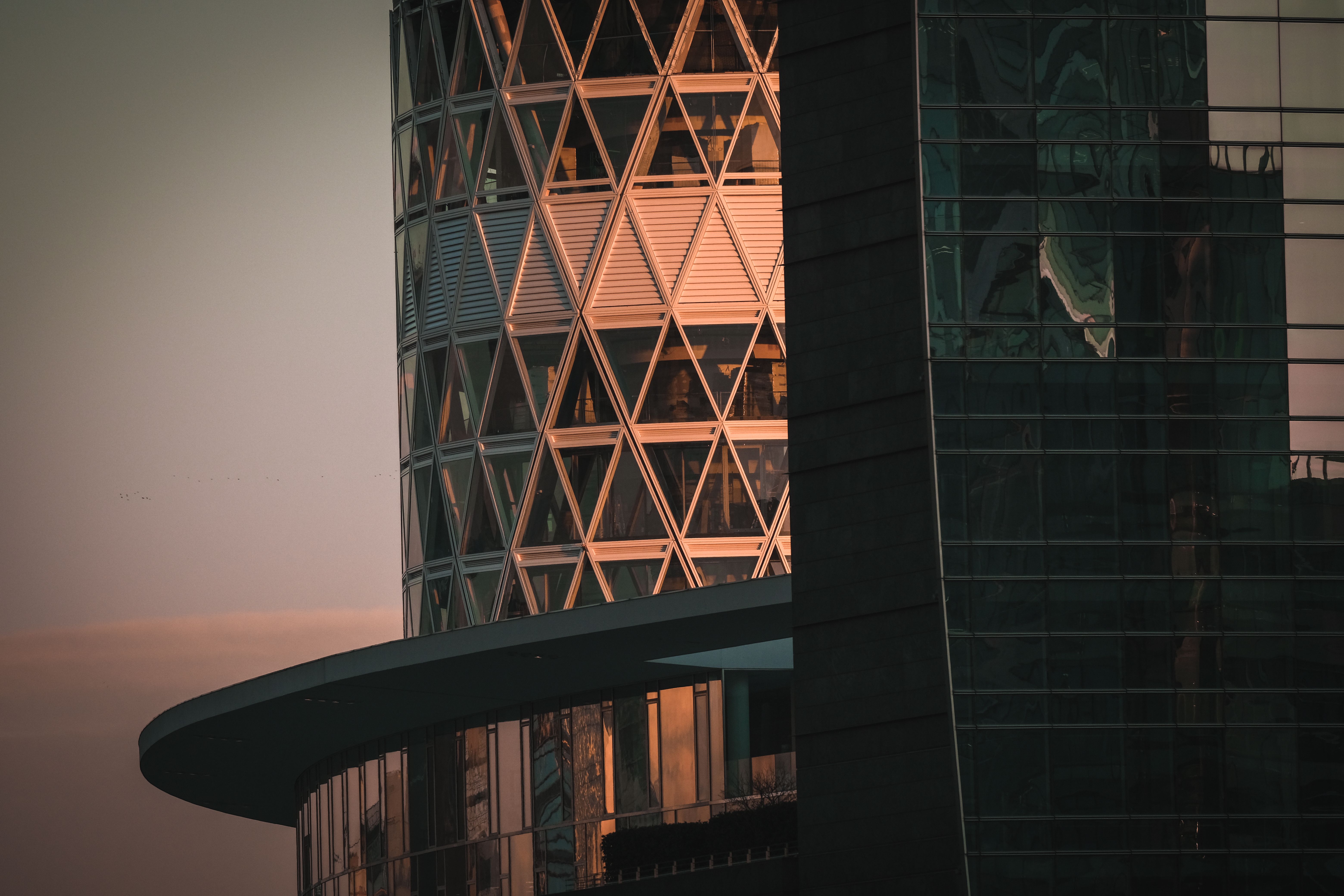 A sophisticated, minimalist executive office with a panoramic view of a global financial hub at dusk.