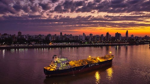 Free Ship Traveling a Body of Water at Sunset Stock Photo
