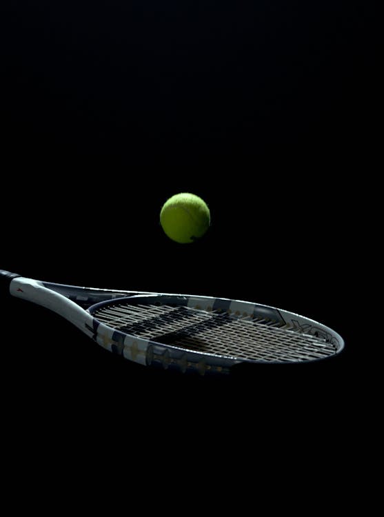 Close Up of Tennis Ball on String or Net of Tennis Racquet, Racket, on  Black Background for Sport for Exercise Hobby and Lifestyle Stock Image -  Image of equipment, competition: 228887653