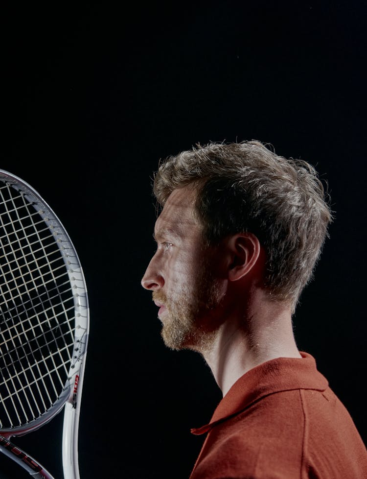 Man Holding A Tennis Racket