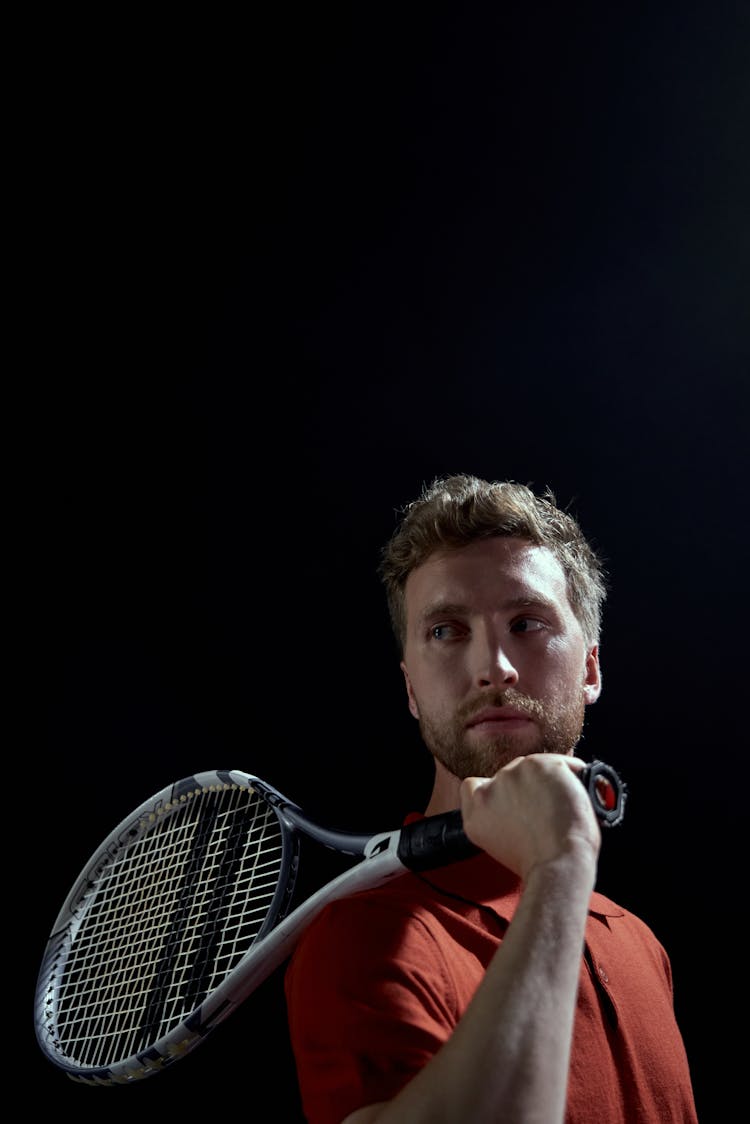 Handsome Man Posing With A Tennis Racket