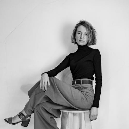 A Woman Sitting Crossed Legs on a Chair