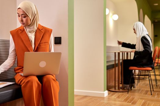 Muslim Women in Hijab Working in Modern Office 