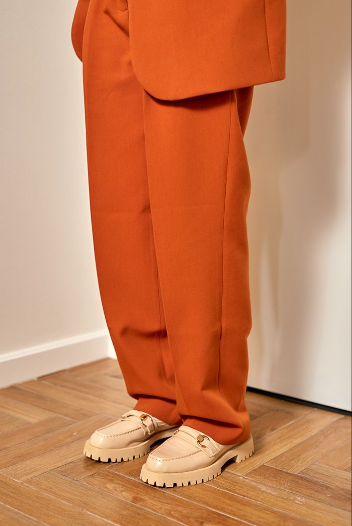 Cream leather lug-sole loafers with rust trousers — photo by Ron Lach on Pexels