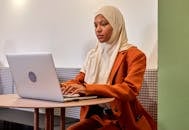 Woman in Hijab Using Laptop in Cafe
