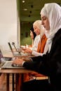 Women in Hijabs Working on Laptops