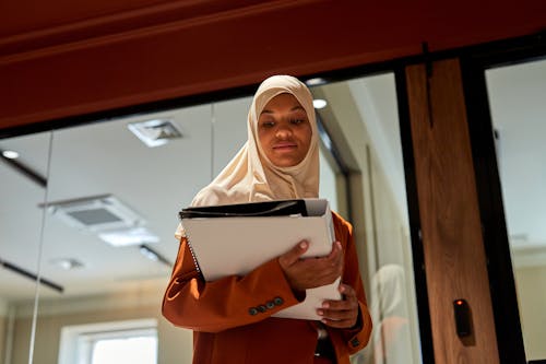 A Low Angle Shot of a Female Wearing Hijab and Working