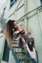 Woman Posing on Fire Escape Railing