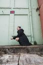 Man in Black Jacket Sitting on Concrete Bench